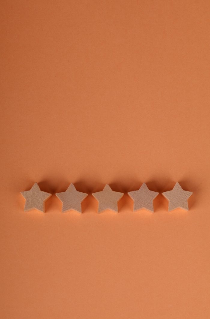 Simple five-star rating on an orange background, showing quality or achievement.